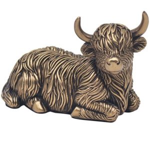 bronze cow laying